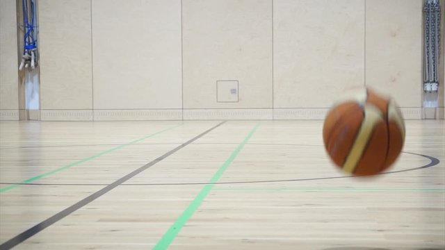 Basketball bouncing through a gym