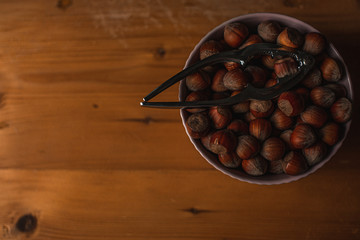 Nuts in bowl on wooden background