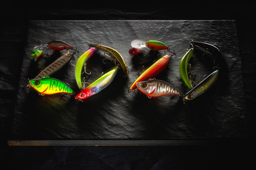 New Year 2020. Plastic fishing lures in the form of the number 2020.Plastic fishing lures BENT MINNOW 106 from OSP, ONETEN LBO from MEGABASS, CHUBBY and CHUBBY VIBRATION from JACKALL.