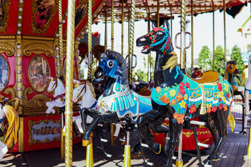 Fototapeta na wymiar Carousel for children with horses attractions in the Park