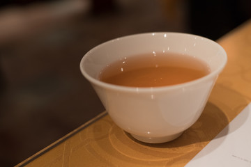 Fototapeta na wymiar a close up view of a white porcelain cup of oolong tea 