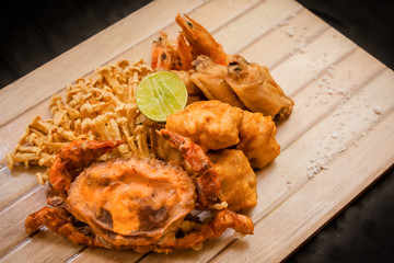 mixed fried asian appetizers, french fries, chicken karaage, chickem wing, shrimp, enoki mushroom, tonkatsu, soft shell crab with salt and lime.