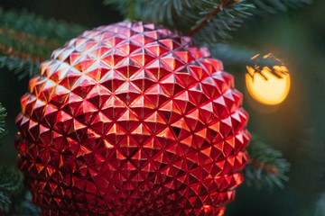 Fototapeta premium Red Geodesic Christmas Tree Ornament Close Up with Background Lights