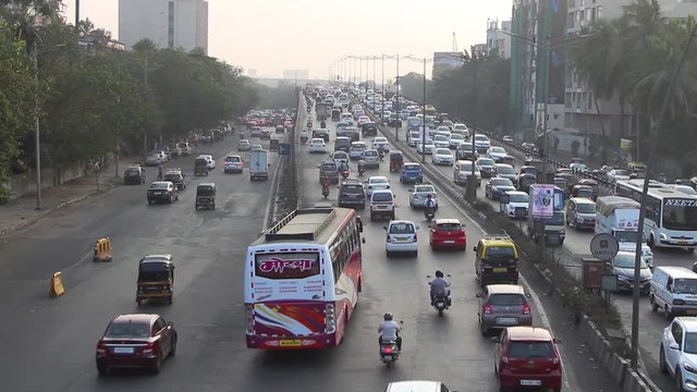 Real time Wide angle footage of Hundreds of Cars passing by on Western Express Highway freeway of Mumbai during evening rush hour. Maharashtra, India. 5803.