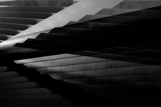 Double exposure photo of metal girders, lath or grid structure. Abstract black and white industrial architecture background with angular structure, polygonal pattern and parallel lines.