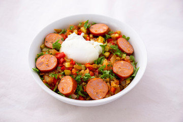 Spanish dish pisto manchego with chorizo sausages and poached egg