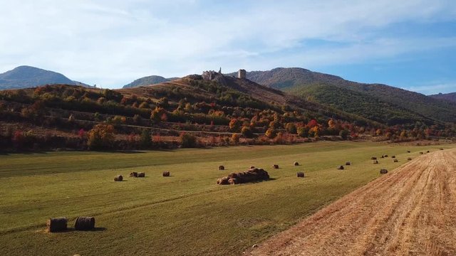 Forward aerial shot towards Coltesti medieval fortress, on a sunny autumn day