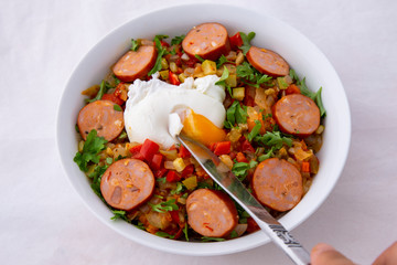 Spanish dish pisto manchego with chorizo sausages and poached egg