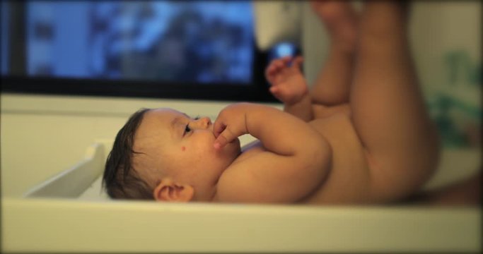 Adorable beautiful baby in changing room at night ritual