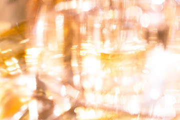 Beautiful bokeh and light reflections in yellow glass perfume bottles