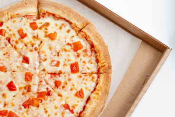 Pizza margarita in a open box on white background