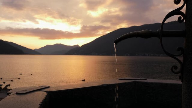 Lugano Lake. Fountain Slow Motion in Bissone, tiny village on the lake