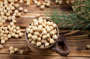 hazelnuts in a decorative cup on wooden boards close-up