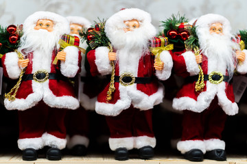 Merry Christmas and Happy new Year , Santa Claus doll with girts in Christmas festival , Copy space. Cute grandfather frost in red costume and gray gloves on tree background. gift and celebration.