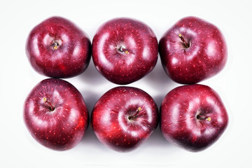 Top view of six dark red apples in rows on white background