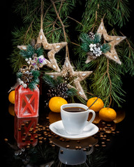 Obraz na płótnie Canvas Coffee cup, tangerines, pine branches, handmade Christmas toys on a black glossy background. Variation of a New Year's card. Festive decoration of the interior.