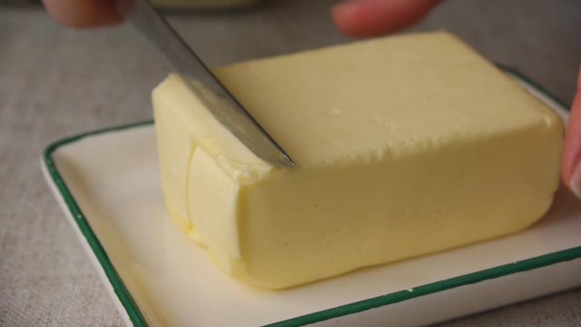 Cutting Off A Piece Of Butter