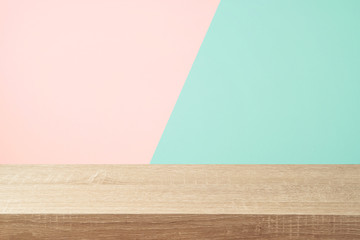 Empty wooden table over pink and mint background. Valentines day or women day concept celebration.