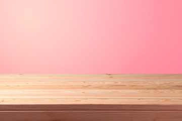 Empty wooden table over pink background. Valentines day concept celebration.
