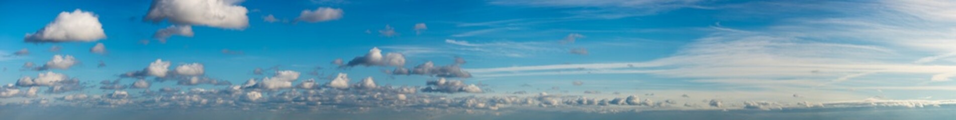 Fantastic clouds against blue sky, panorama