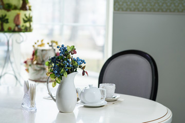 Fototapeta na wymiar Danish with cherries and black tea on a table in a cozy coffee shop