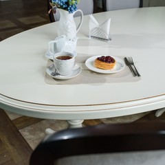 Danish with cherries and black tea on a table in a cozy coffee shop