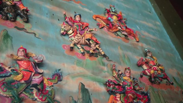 Religious colorful sculpture in China temple. Holy moments from religious texts in East culture. Art buddhist artwork spectacular temple. Chinese new year temple during New Year and lantern festival.