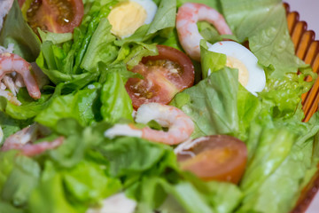 Tomatoes, shrimps, eggs and green salad. Closeup