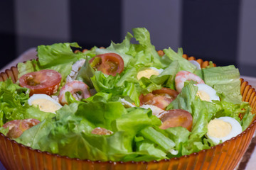 Tomatoes, shrimps, eggs and green salad. Closeup
