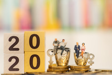 Wooden word number 2020 with business team reading newspaper on blurred city scape and copy space for text using as background business investment, new year, real estate, property concept.