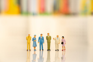 Miniature people: Group of business team standing on white background with copy space using as background business, social media concept.