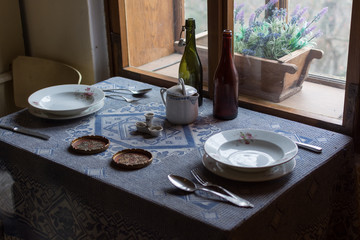 Vintage served table at window in old house. Village