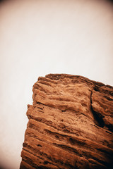 big red rock with white sky