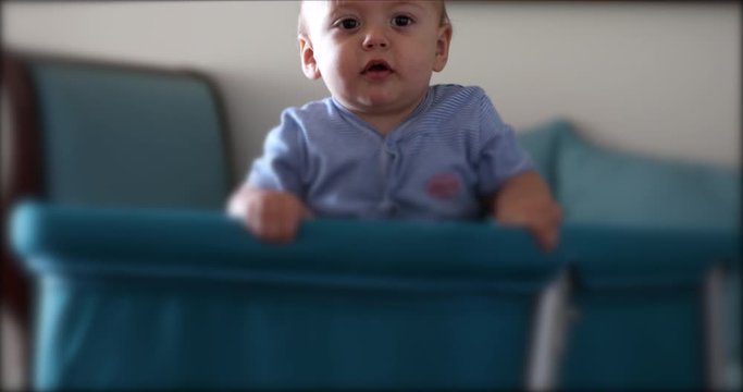 Baby head peeking out from craddle crib box