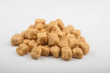 A pile of brown sugar on a white background.