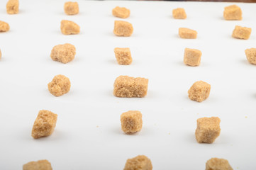 Pieces of brown sugar on a white background.