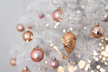 Decorated christmas tree with pink and golden toys on white background. Christmas concept, 2020.