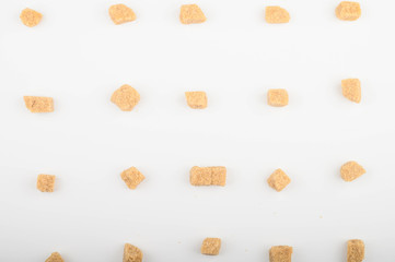 Pieces of brown sugar on a white background.