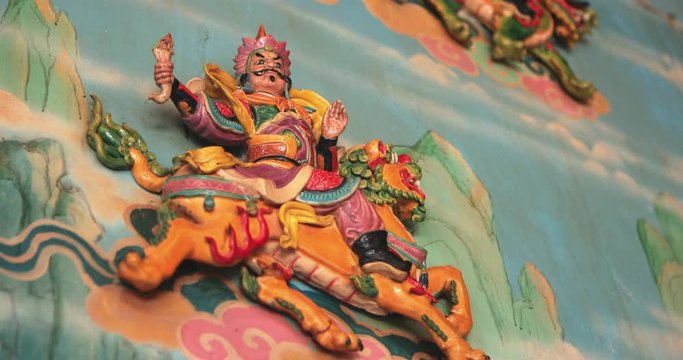 Religious colorful sculpture in China temple. Holy moments from religious texts in East culture. Art buddhist artwork spectacular temple. Chinese new year temple during New Year and lantern festival.