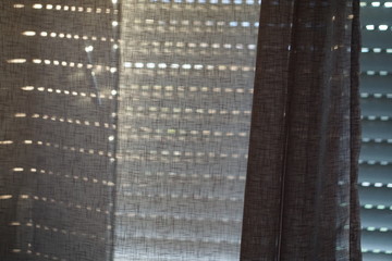 sunlight shines from outside into the darkened room