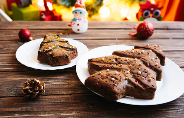 Homemade Christmas cake in the shape of a Christmas tree on a wooden table