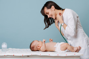pediatrician doctor communicates and plays with baby