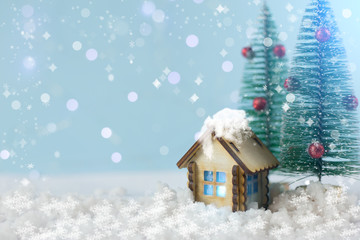 the concept of new year and Christmas. wooden house on a blue background with Christmas trees.