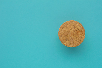 Eco friendly minimalist background. Top view at cork stopper on bright blue paper backdrop. Natural eco lifestyle.