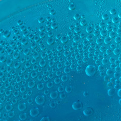 Blue water drops background close up