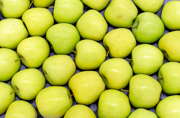 Green apples in a vegetable shop. Background from green apples.