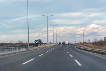 vehicles are moving along the road, view from the car
