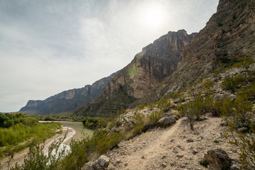 A river cuts through to form a canyon in the desert of West Texas.