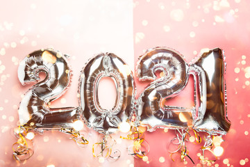 Balloon Bunting for celebration of New Year 2021 made from Silver Number Balloons. Holiday Party Decoration or postcard concept with top view and copy space.