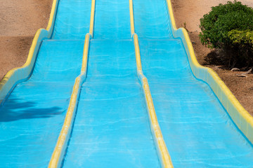 Empty bright blue waterslide in an aguapark.